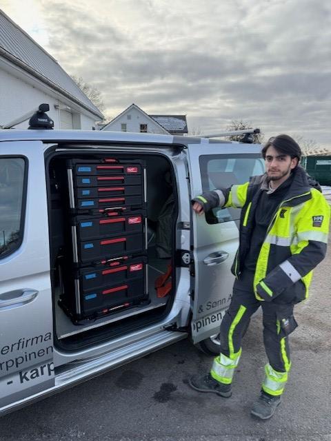 Kunde foran bilen med døren åpen for å vise Packout